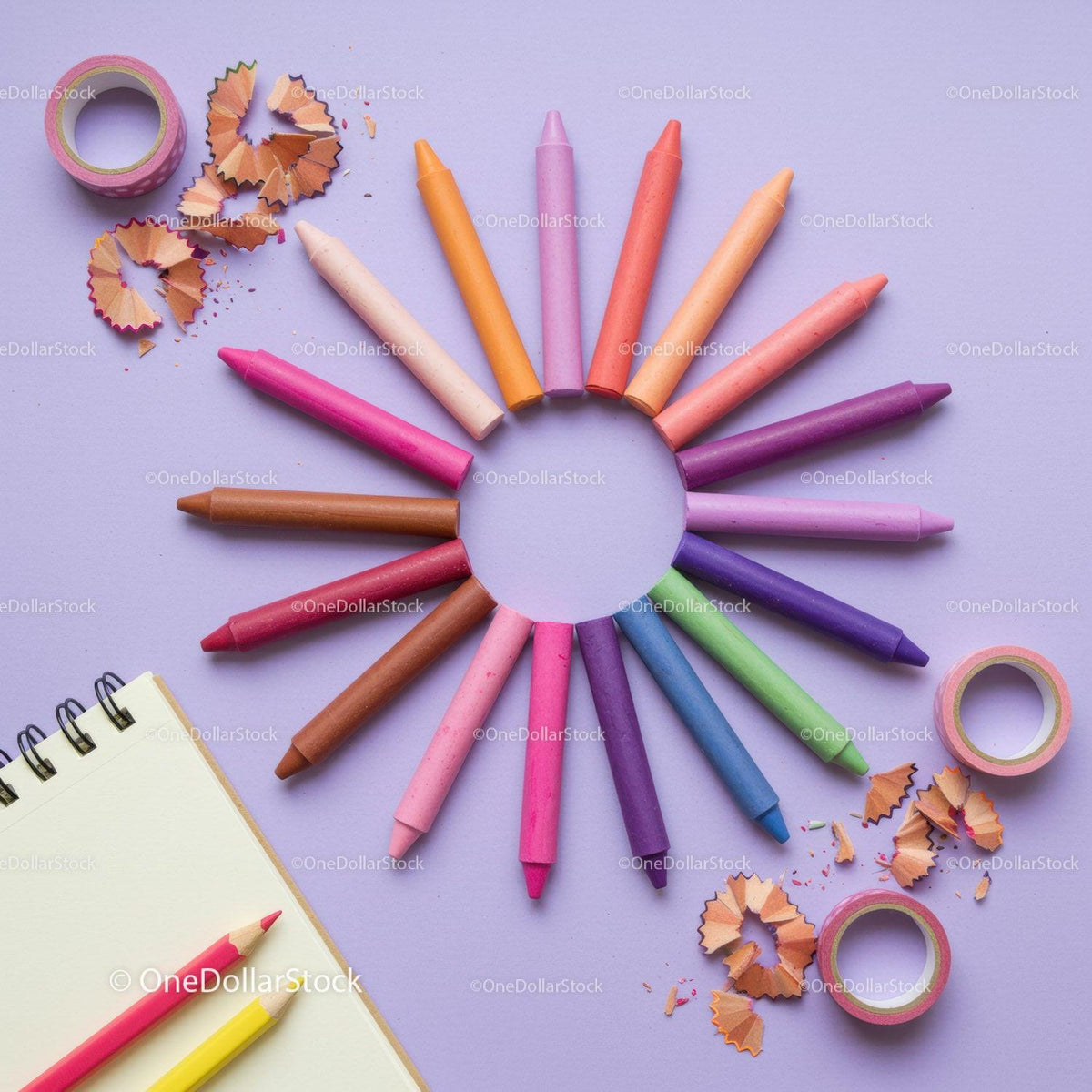 Colorful crayons arranged in circular pattern on purple background