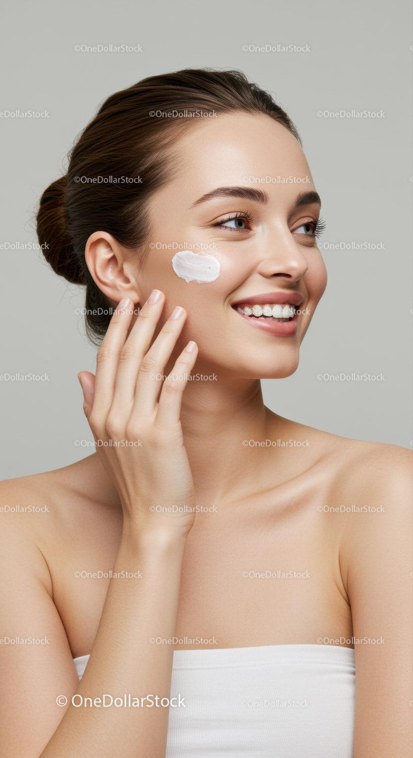 Portrait of a Smiling Woman Applying Cream for Skincare Routine