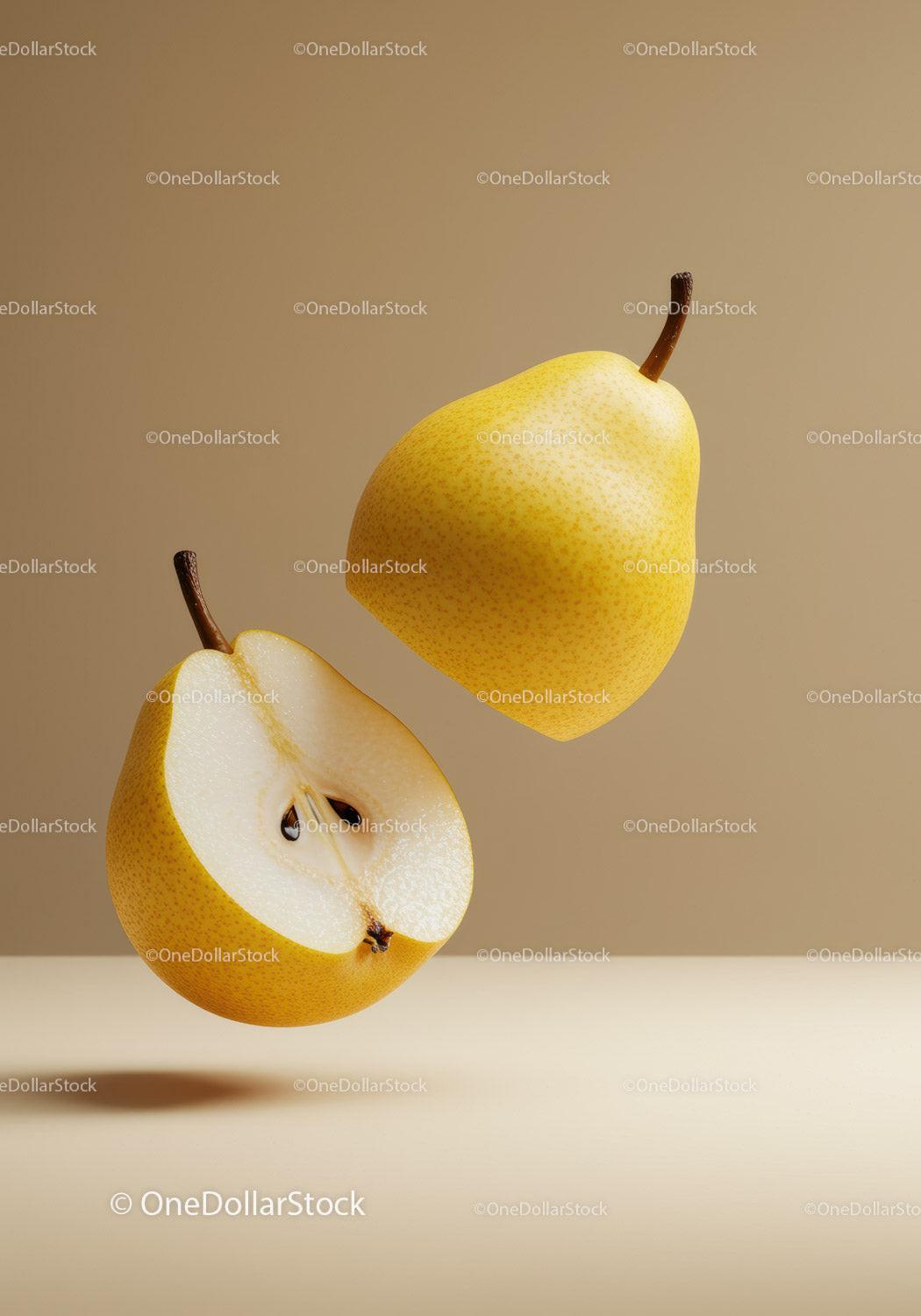Fresh yellow pears with one cut in half on beige background