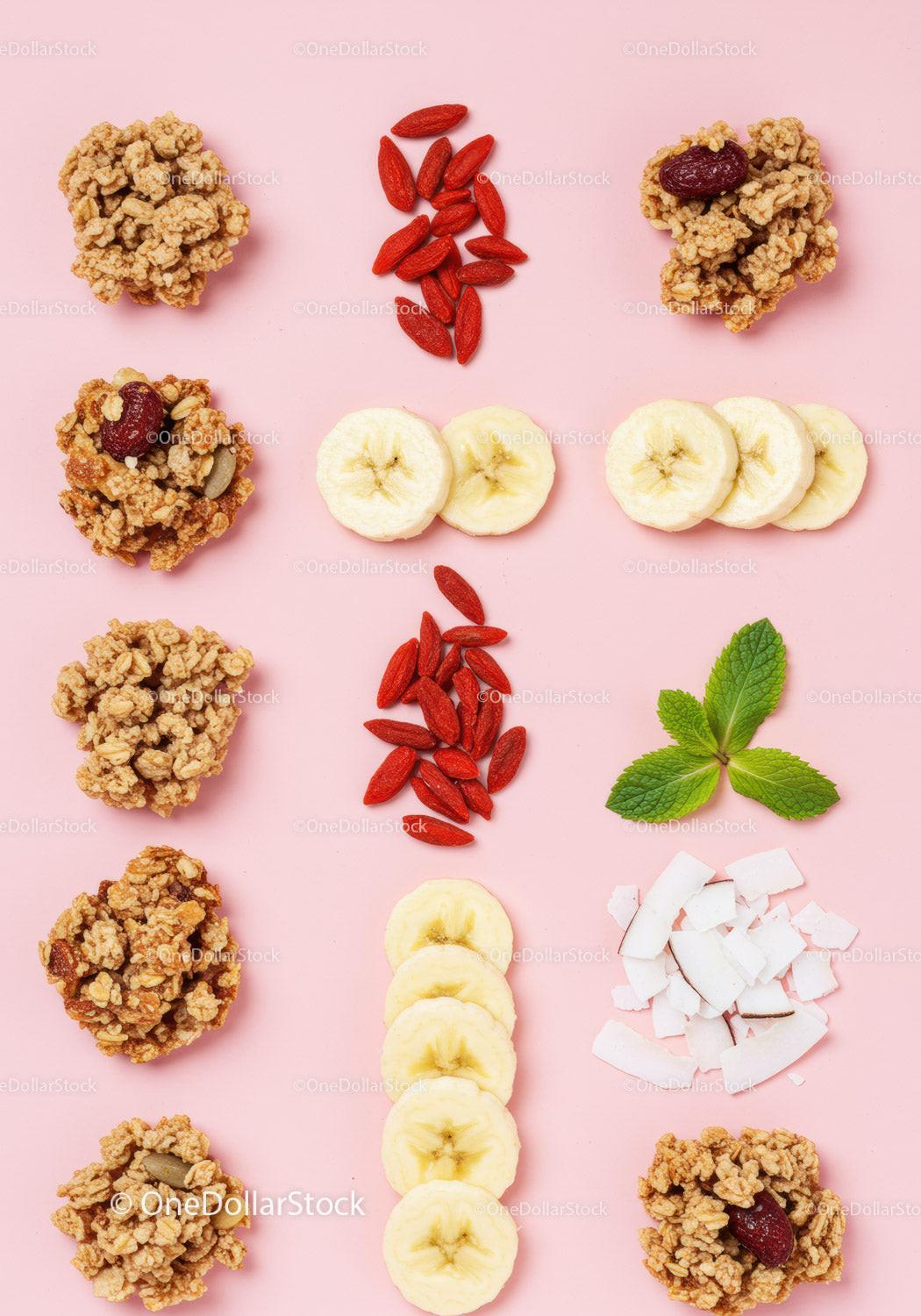 Natural ingredients and granola clusters arranged on pink