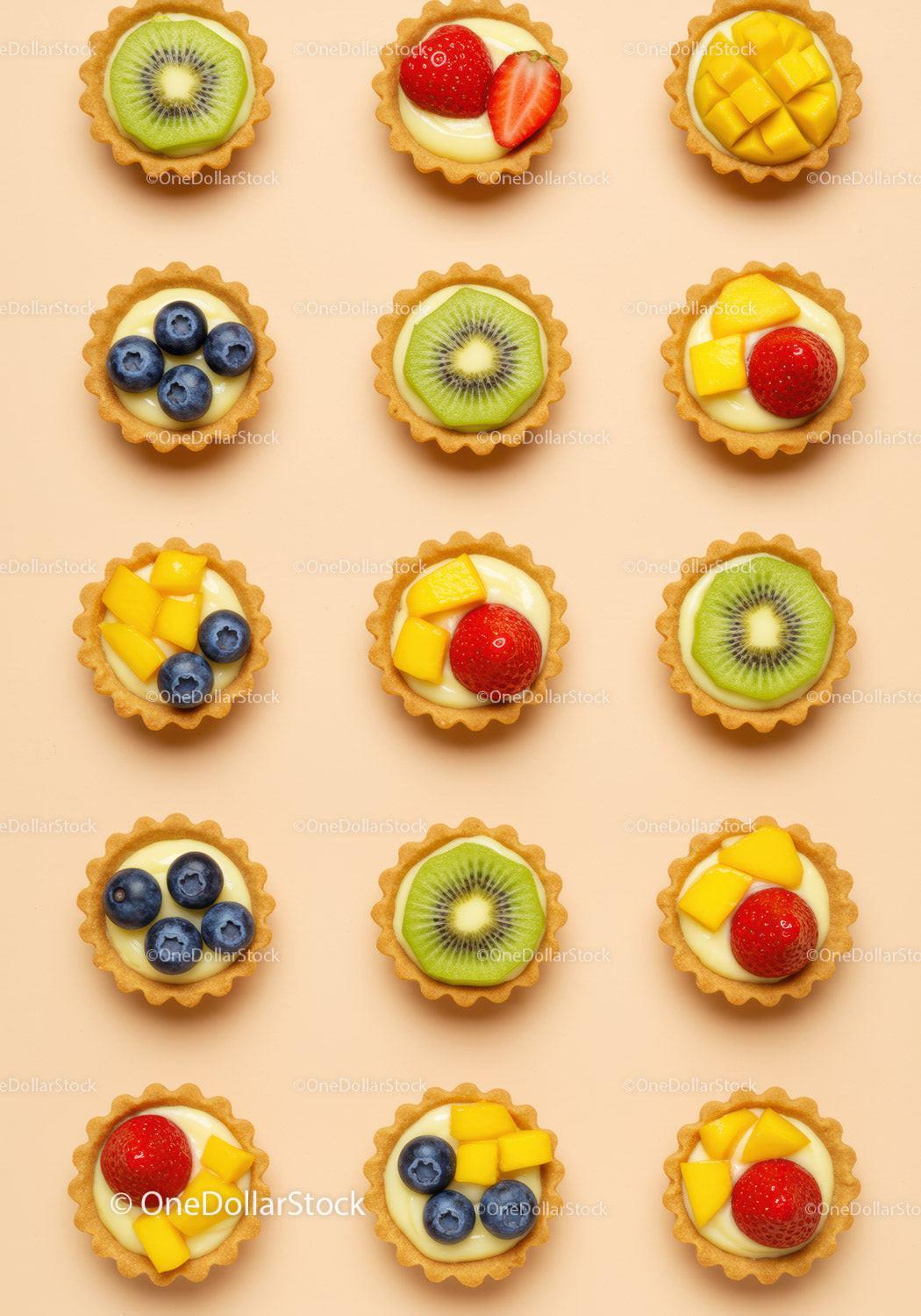 Mini fruit tarts arranged in neat grid on beige background