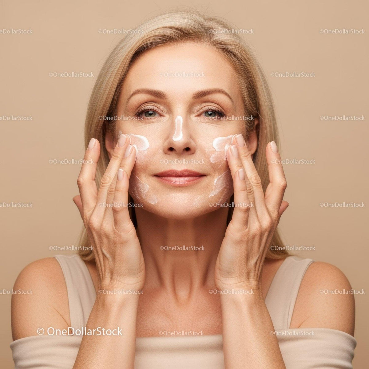 Elegant Mature Woman Applying Facial Cream for Healthy Skin
