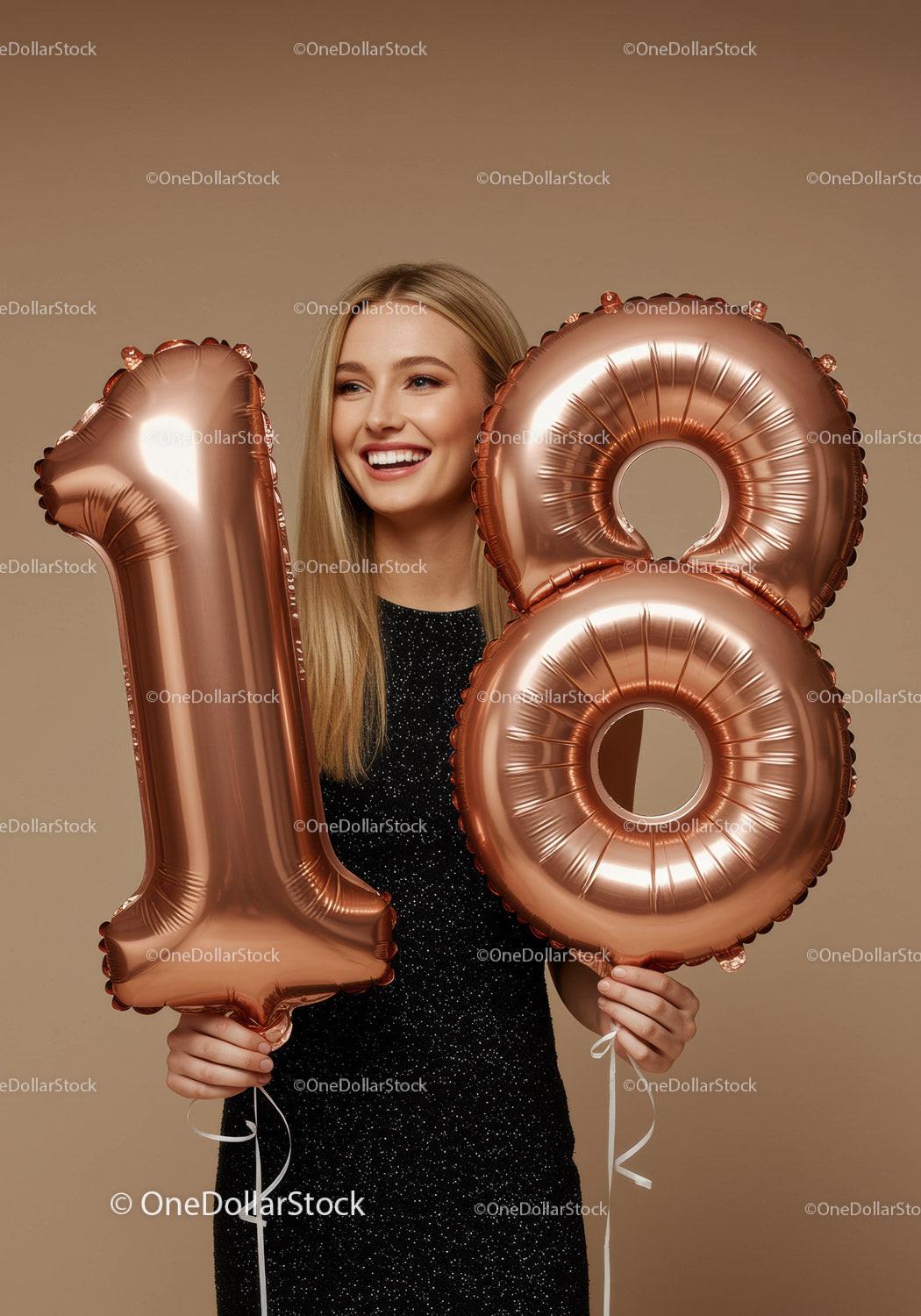 Smiling young woman celebrating 18th birthday with balloons