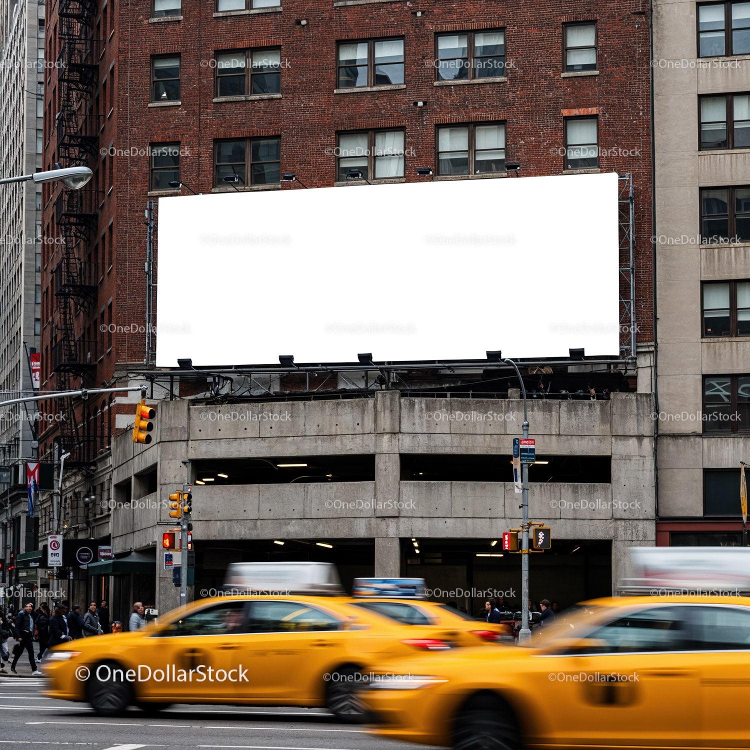 Busy city street with yellow taxis passing billboard