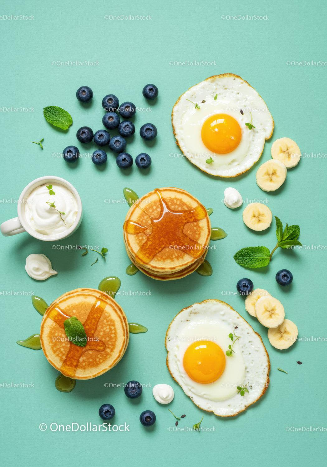 Breakfast Spread with Pancakes Eggs Blueberries and Banana