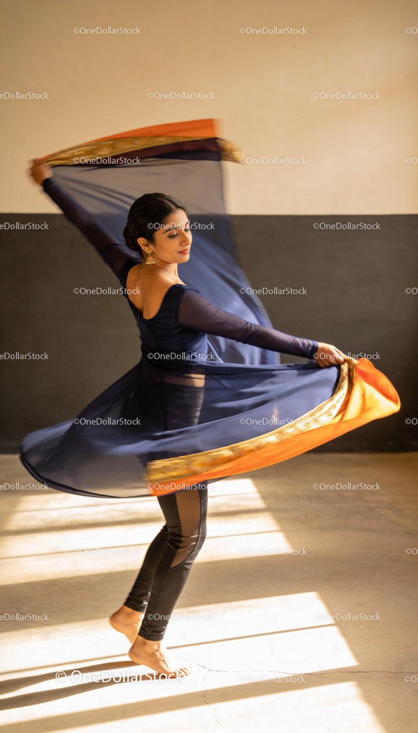 Graceful dancer spinning with flowing scarf in motion