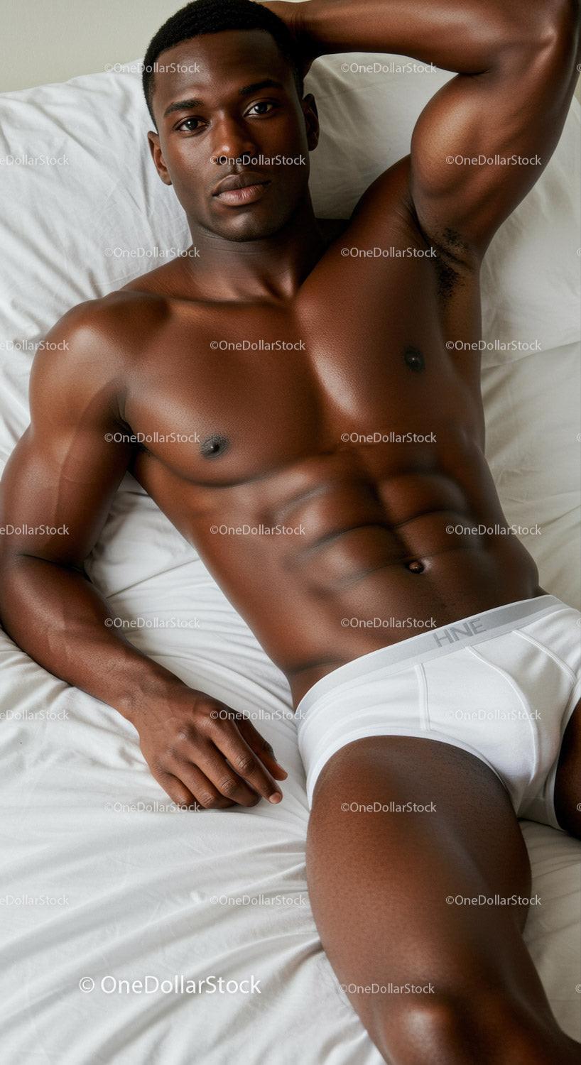Athletic man relaxing on bed in white underwear