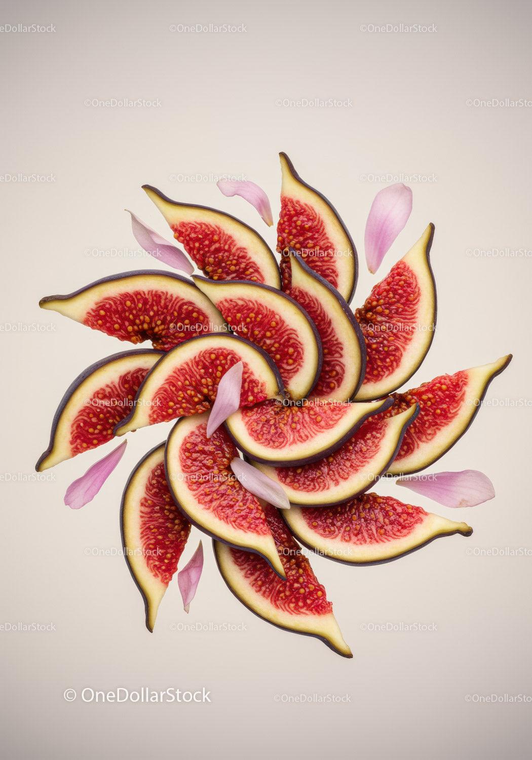 Fresh fig slices arranged with soft pink petals on beige