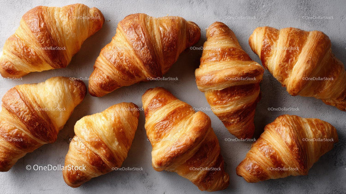 Golden Croissants with Flaky Layers on Grey Surface