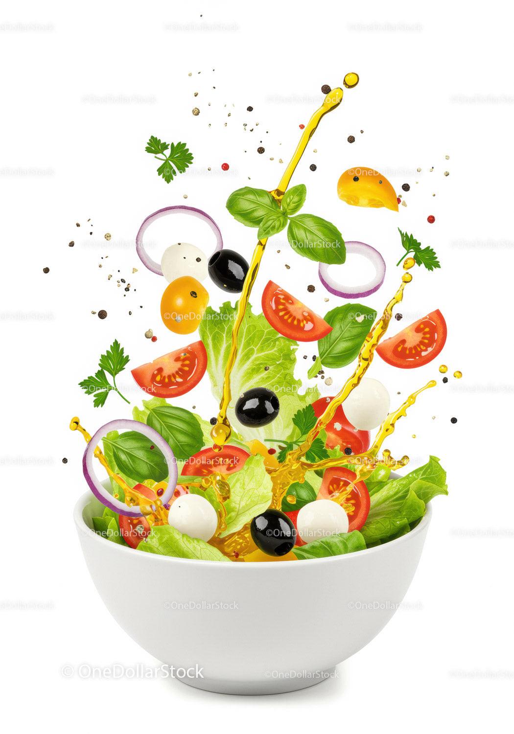 Fresh mixed salad with olive oil splash in white bowl