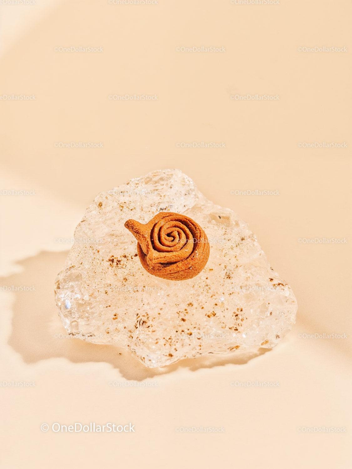 Unique rose-shaped clay sculpture on textured glass