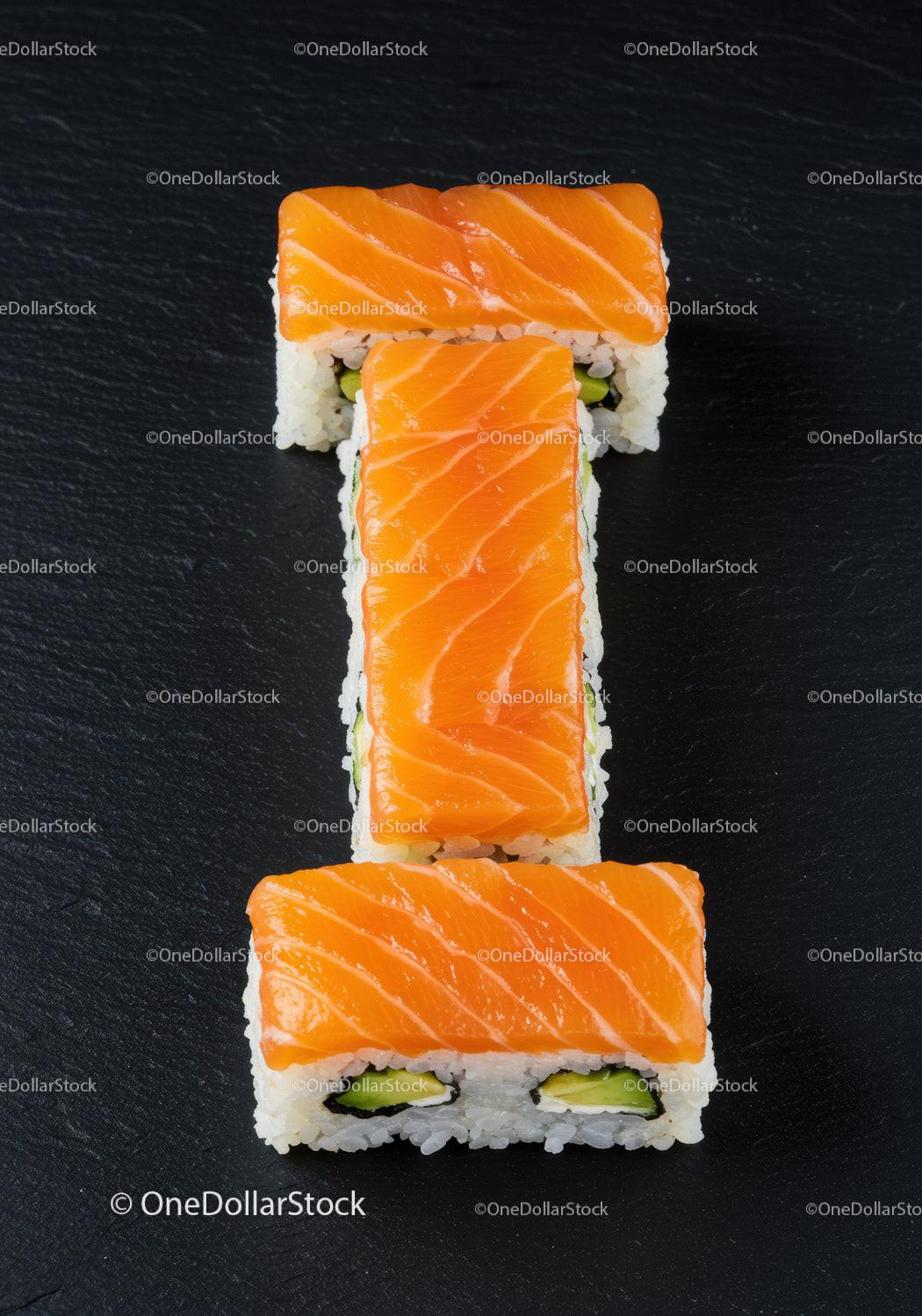 Fresh salmon sushi rolls arranged in letter I shape