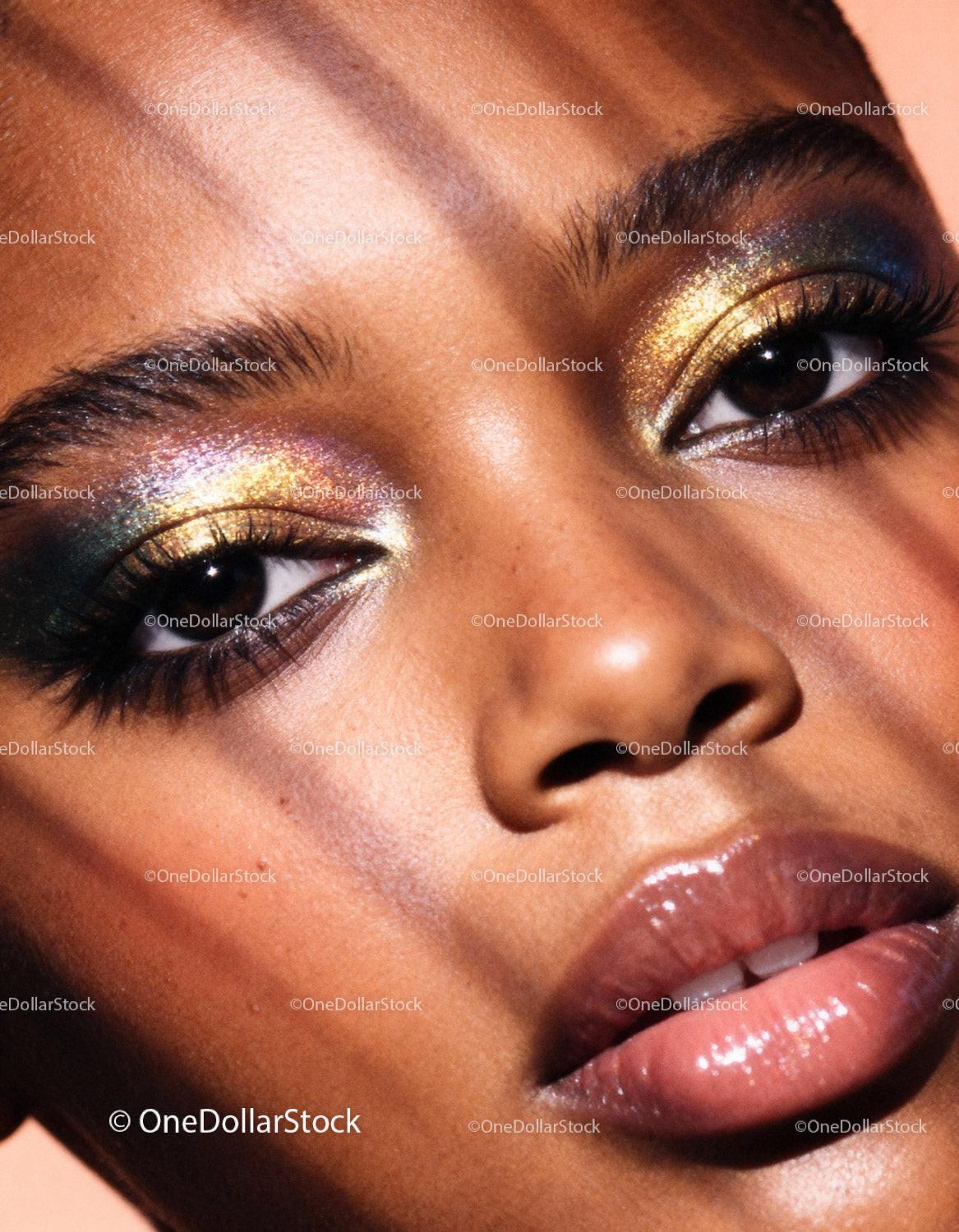 Close-up of woman with vibrant shimmering eye makeup