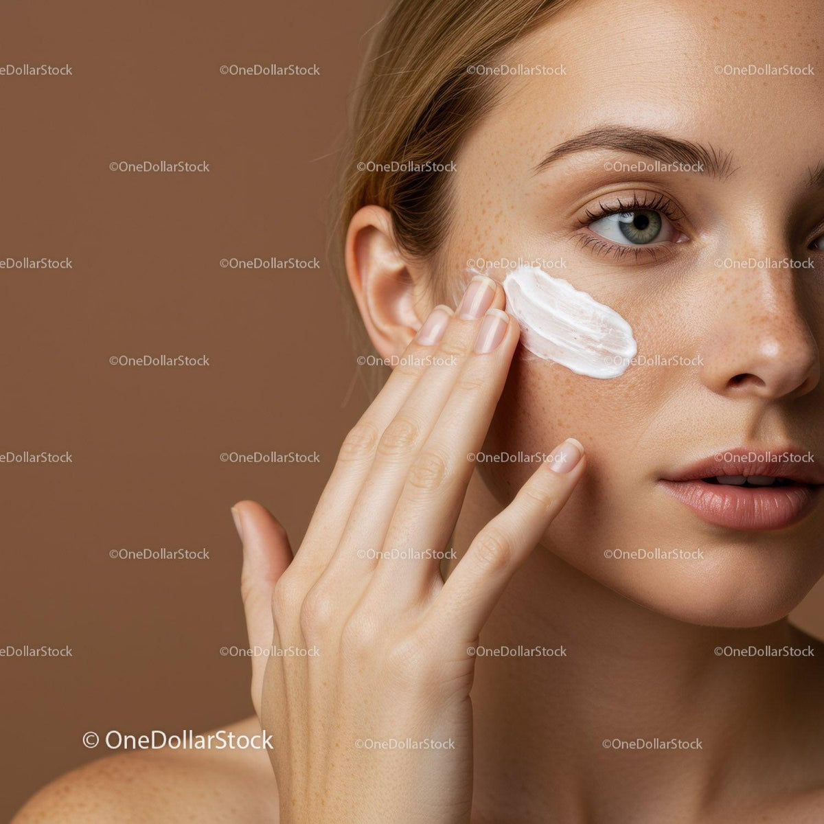 Close-Up of a Woman Applying Facial Moisturizer for Healthy Glowing Skin