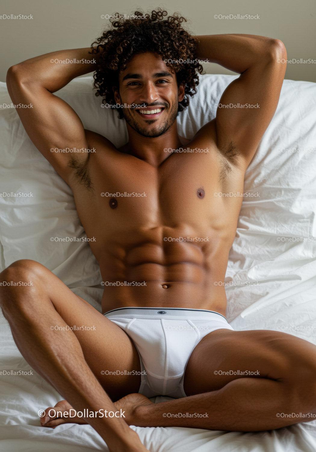 Smiling man relaxing on bed in white underwear