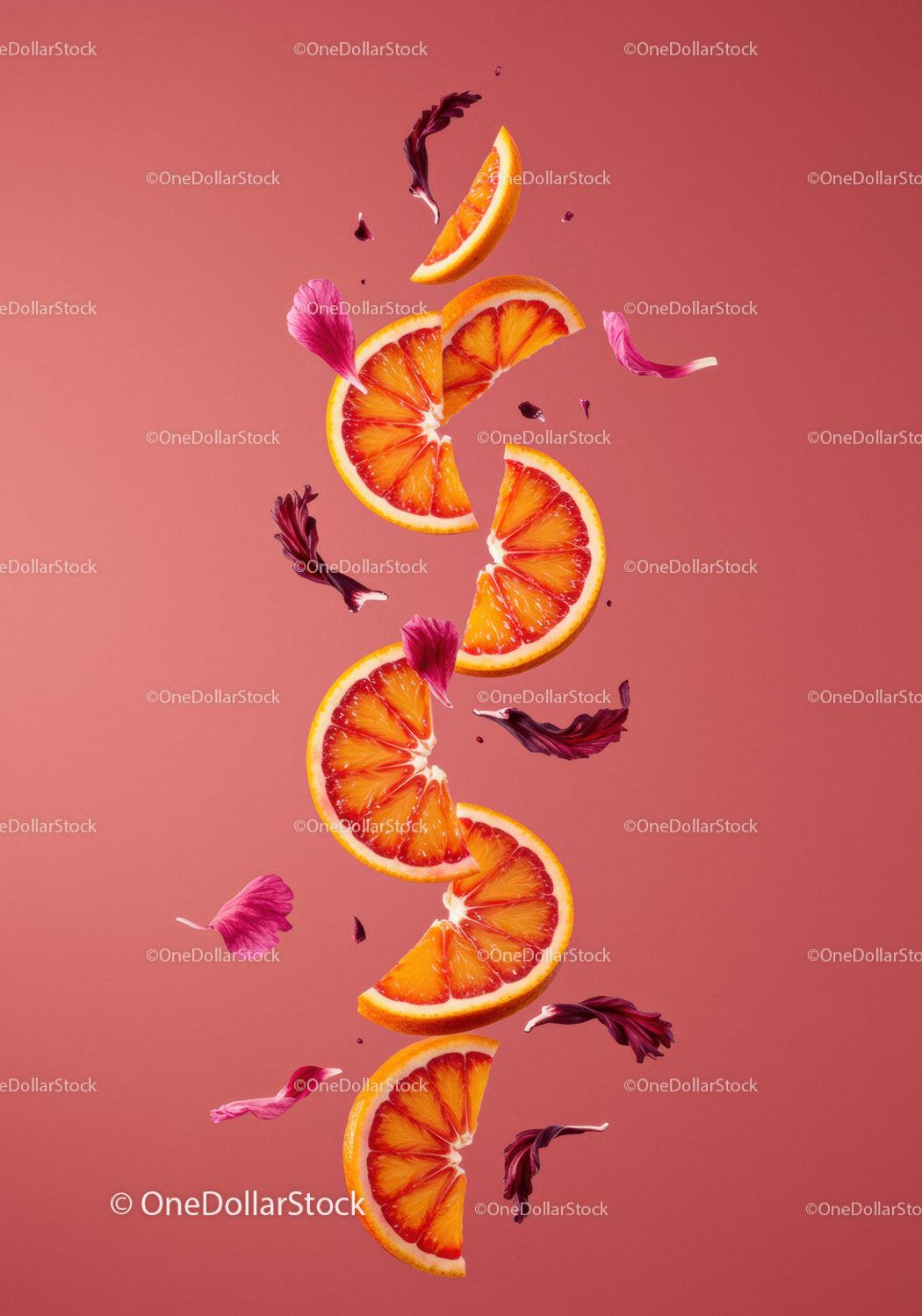 Fresh blood orange slices with vibrant petals floating