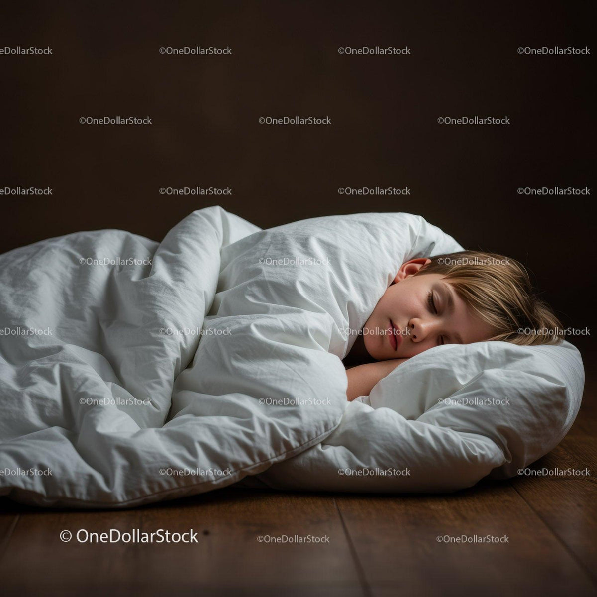 Peaceful child sleeping wrapped in white comforter