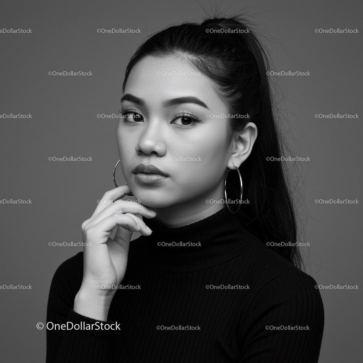 Elegant Black and White Portrait of a Young Woman with Hoop Earrings