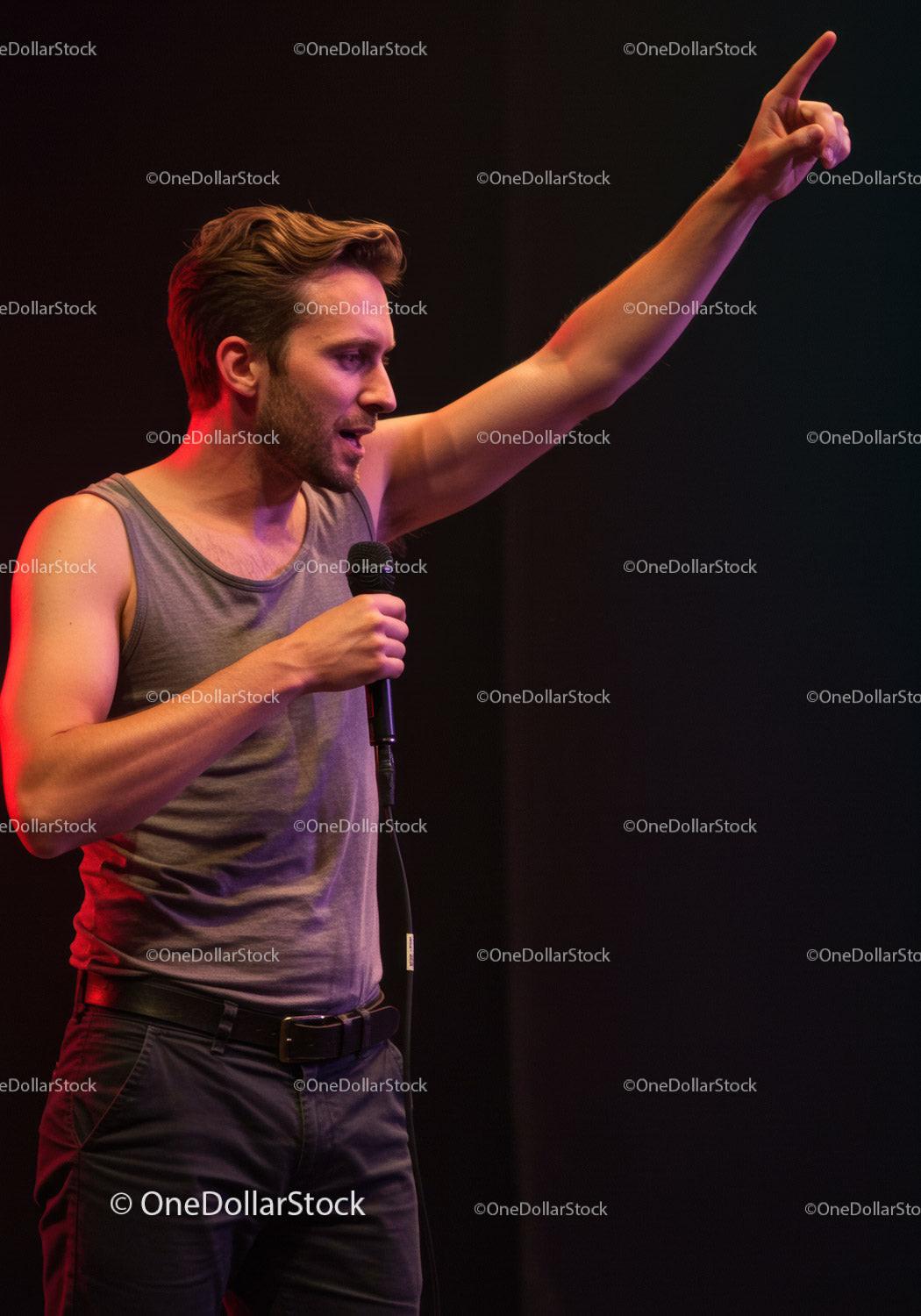 Young man passionately speaking on stage with microphone