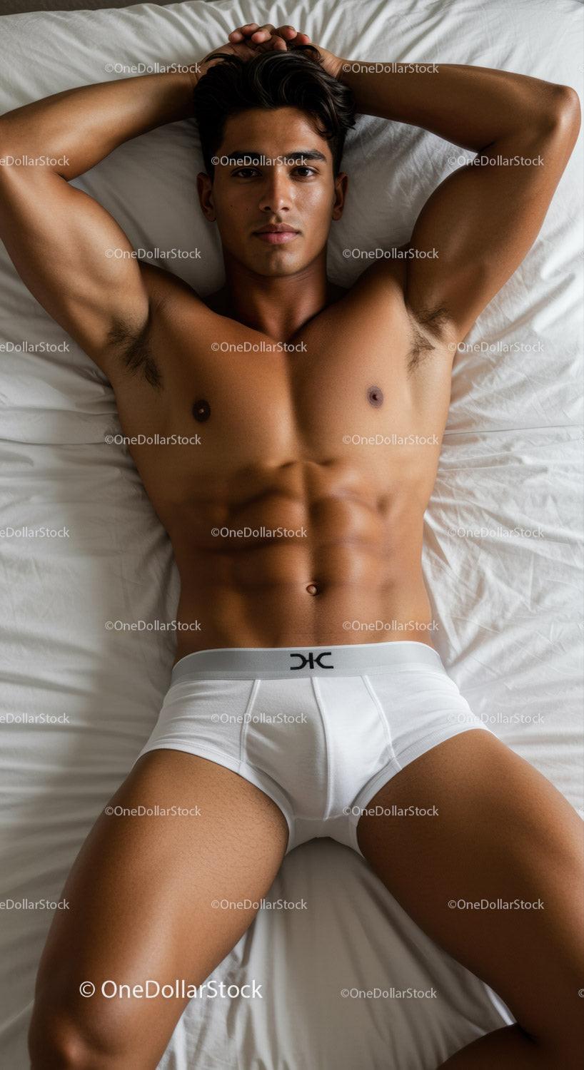 Relaxed young man lying on bed in white underwear