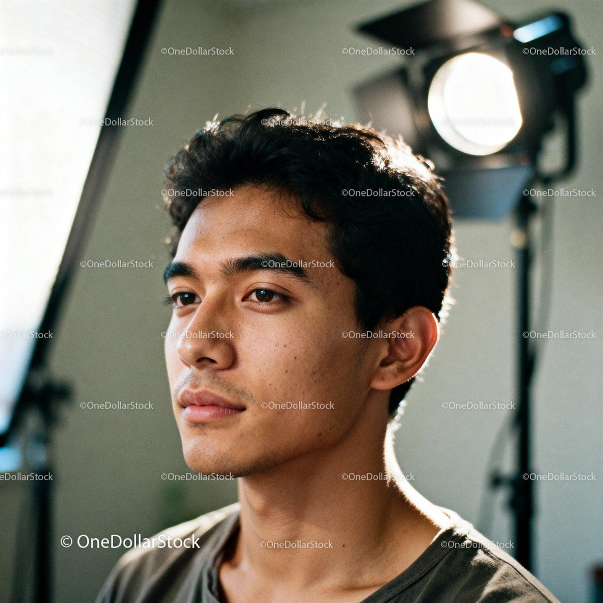 Young man thoughtfully gazing in a studio setting