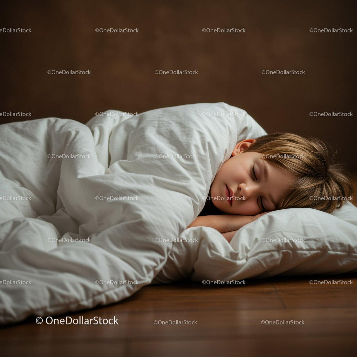 Peaceful child sleeping comfortably under white blanket