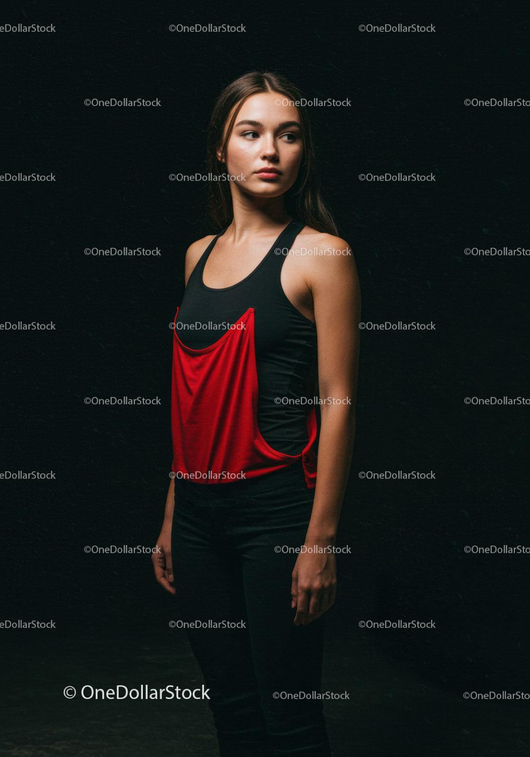 Thoughtful young woman standing against dark background