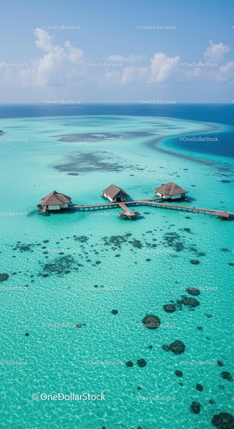 Overwater Bungalows Overlooking Blue Turquoise Lagoon Under Sunny Sky