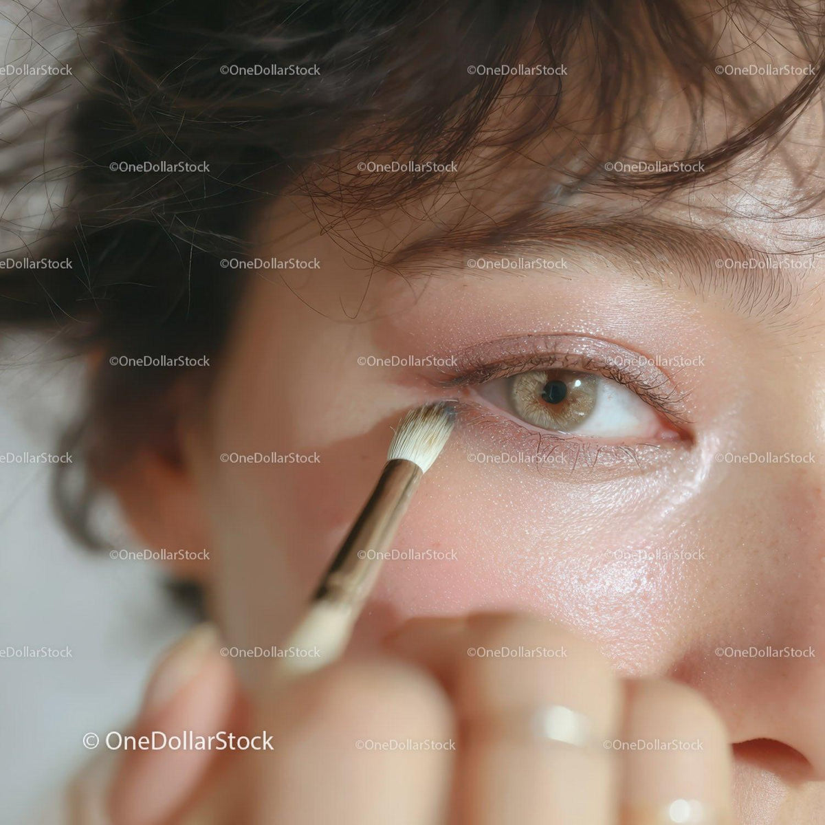 Close-up of Woman Applying Eyeshadow with Makeup Brush