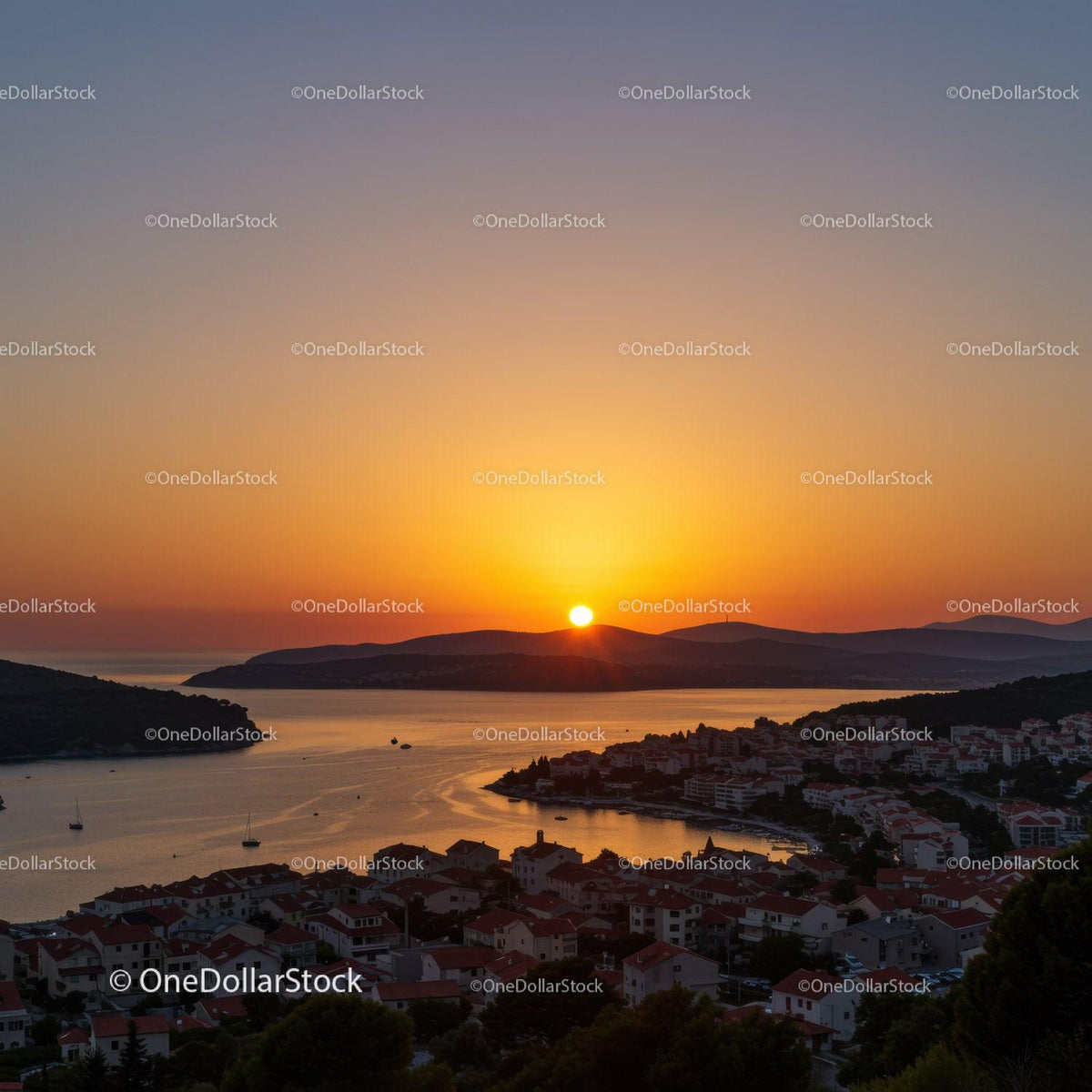 Beautiful Sunset Over Coastal Town with Boats and Hills