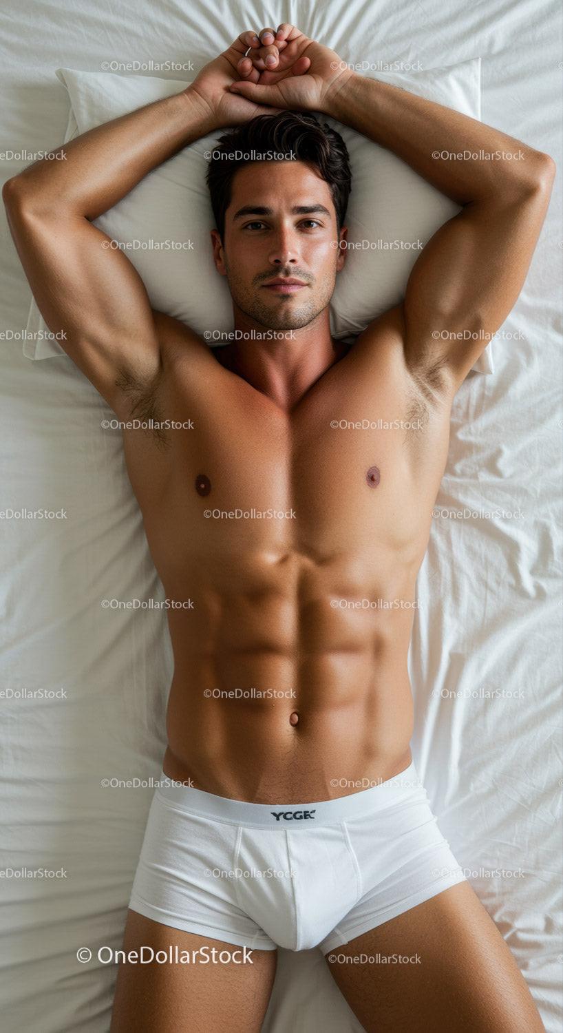 Fit young man relaxing on bed in white underwear