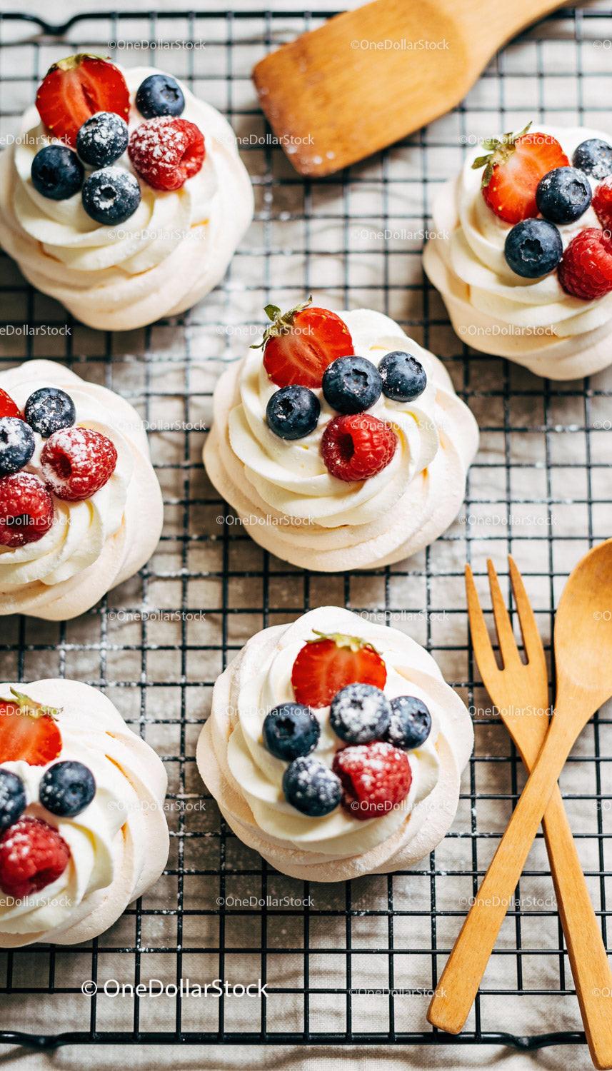 Mini Pavlova Desserts with Fresh Berries on Cooling Rack