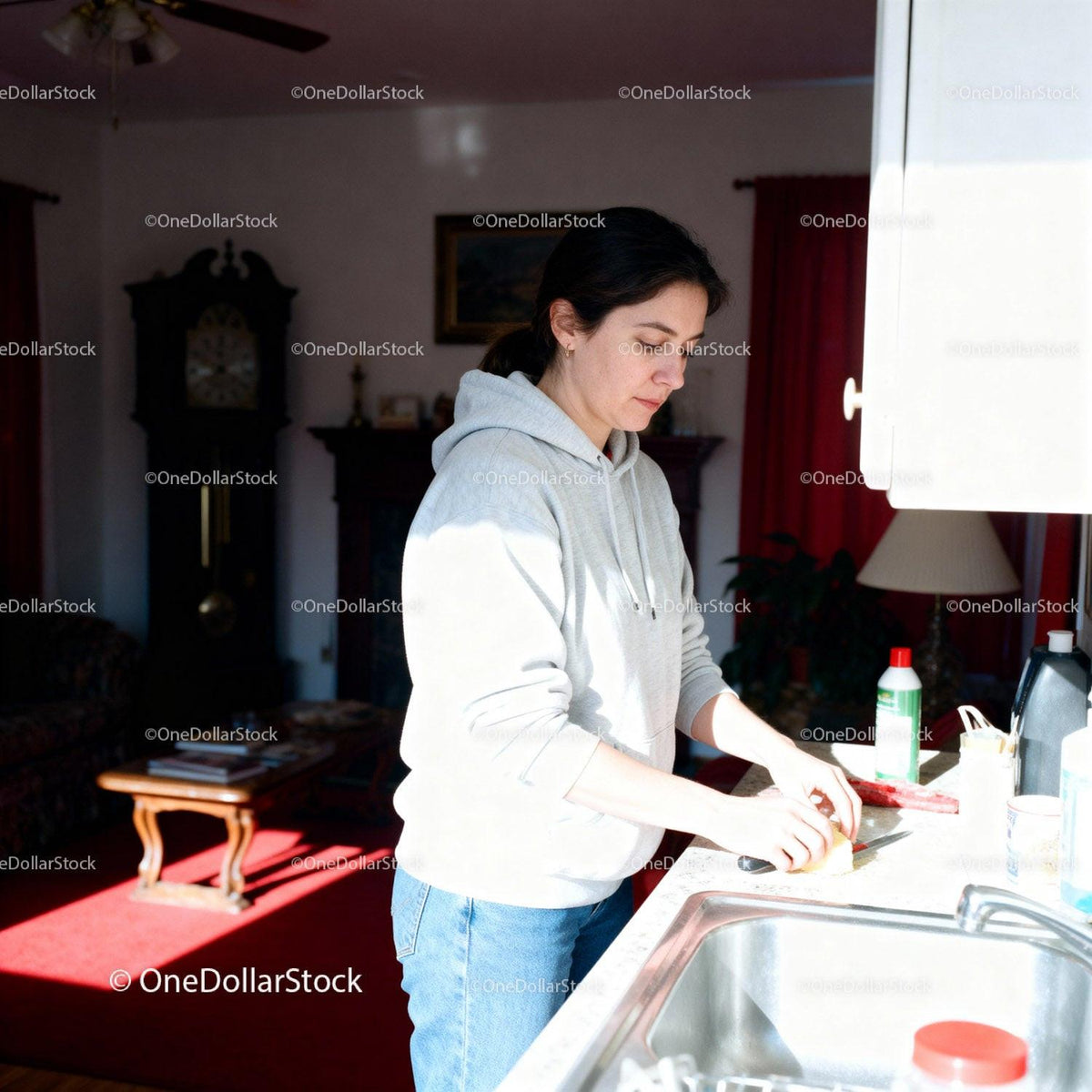 Casual woman washing dishes in bright kitchen space