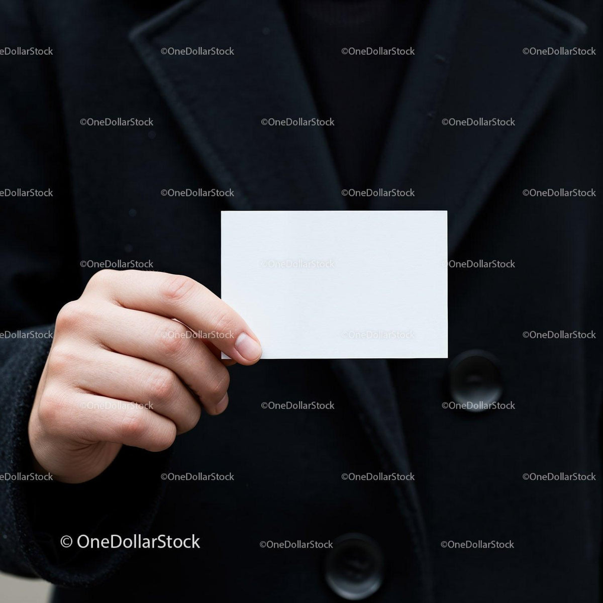 Person holding blank white business card in black coat JPG Mockup Image preview