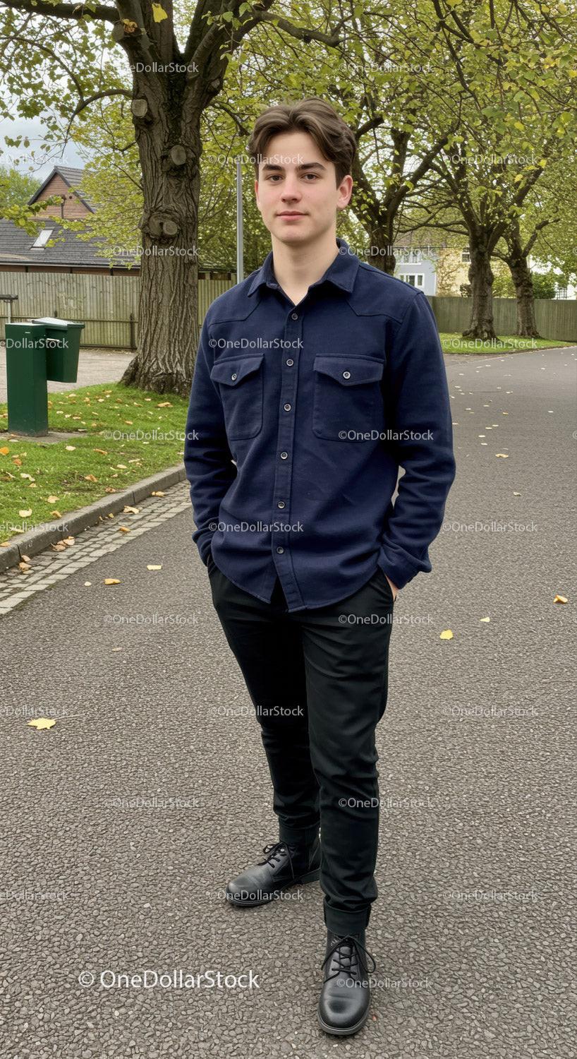 Young man standing confidently on a leafy suburban street