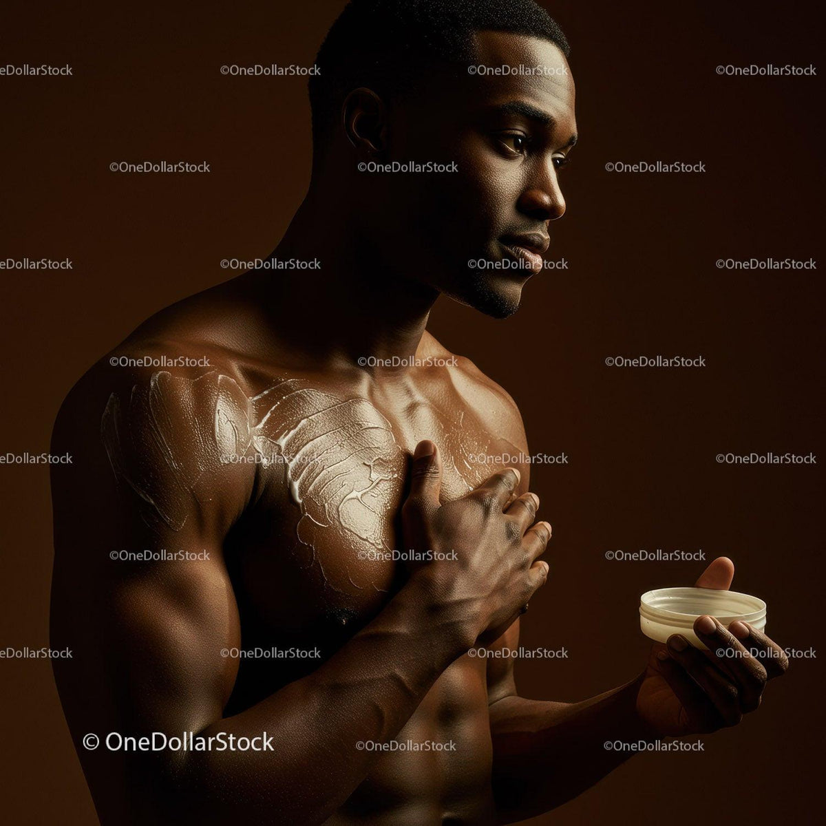 Male with moisturized dark skin applying body lotion for skincare routine