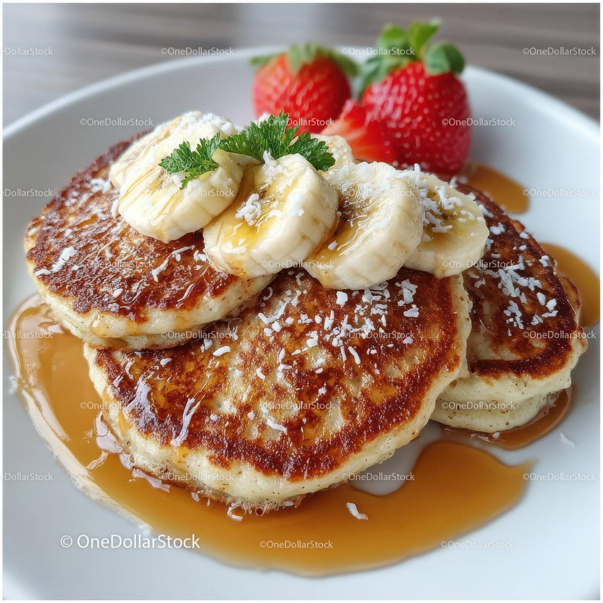 Banana French Toast with Strawberries and Syrup on a White Plate