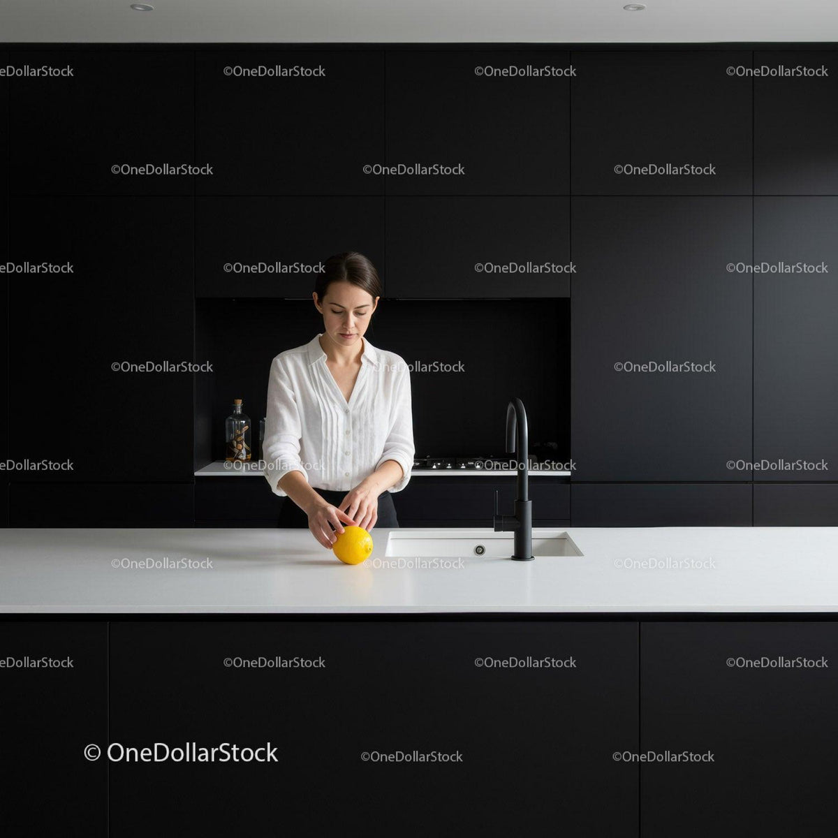 Woman preparing lemon in modern minimalist kitchen