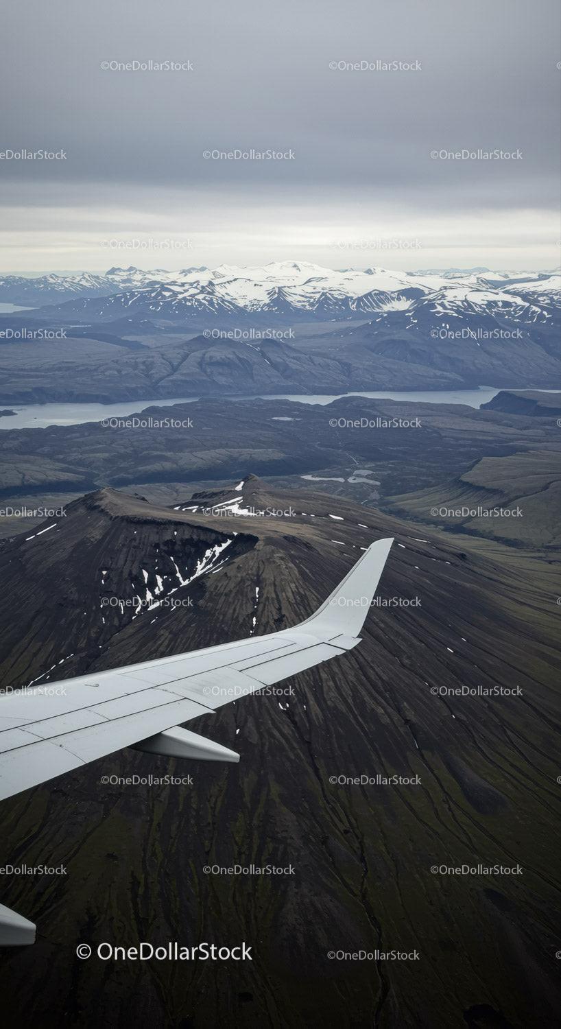 Aerial View of Snow-Capped Mountains and Volcanoes Over Fjords