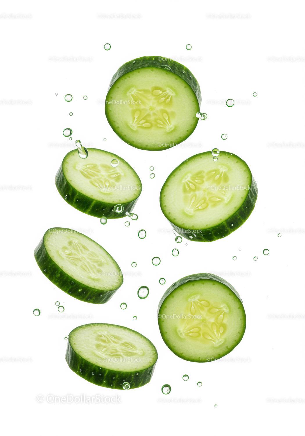 Fresh cucumber slices floating in clear water bubbles