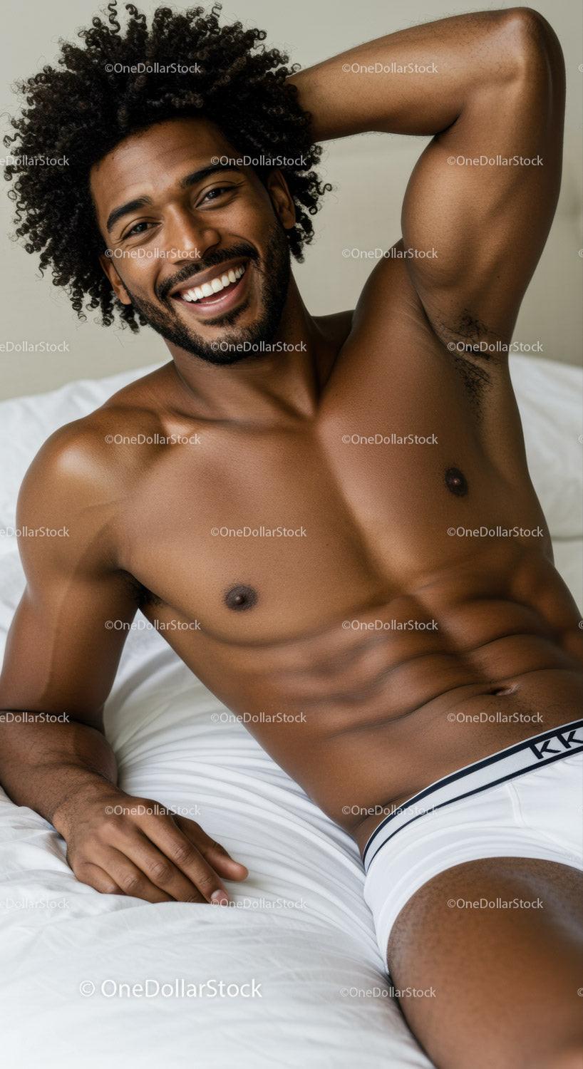 Smiling man relaxing on bed in white underwear