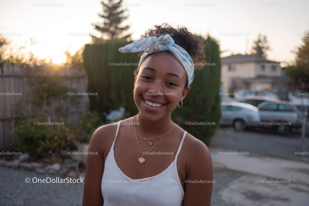 Portrait of a Happy Young Woman Outdoors with Bright Smile and Urban Background