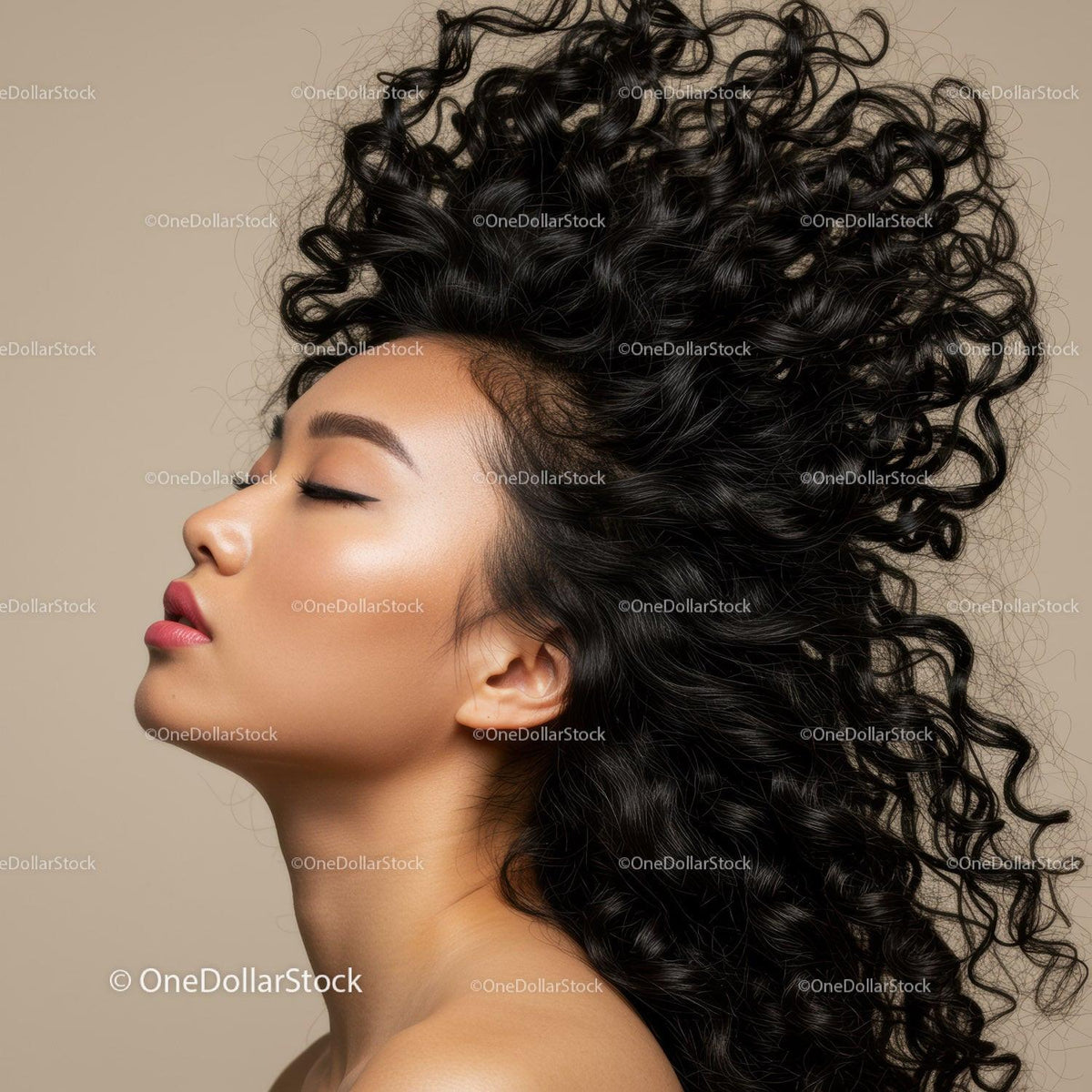 Profile of woman with flowing curly hair and closed eyes