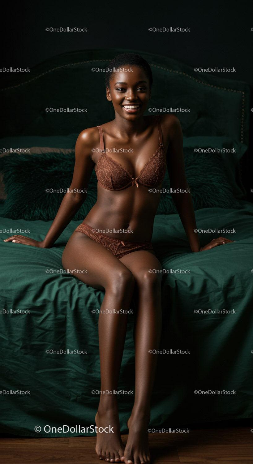 Smiling woman in brown lingerie sitting on emerald bed