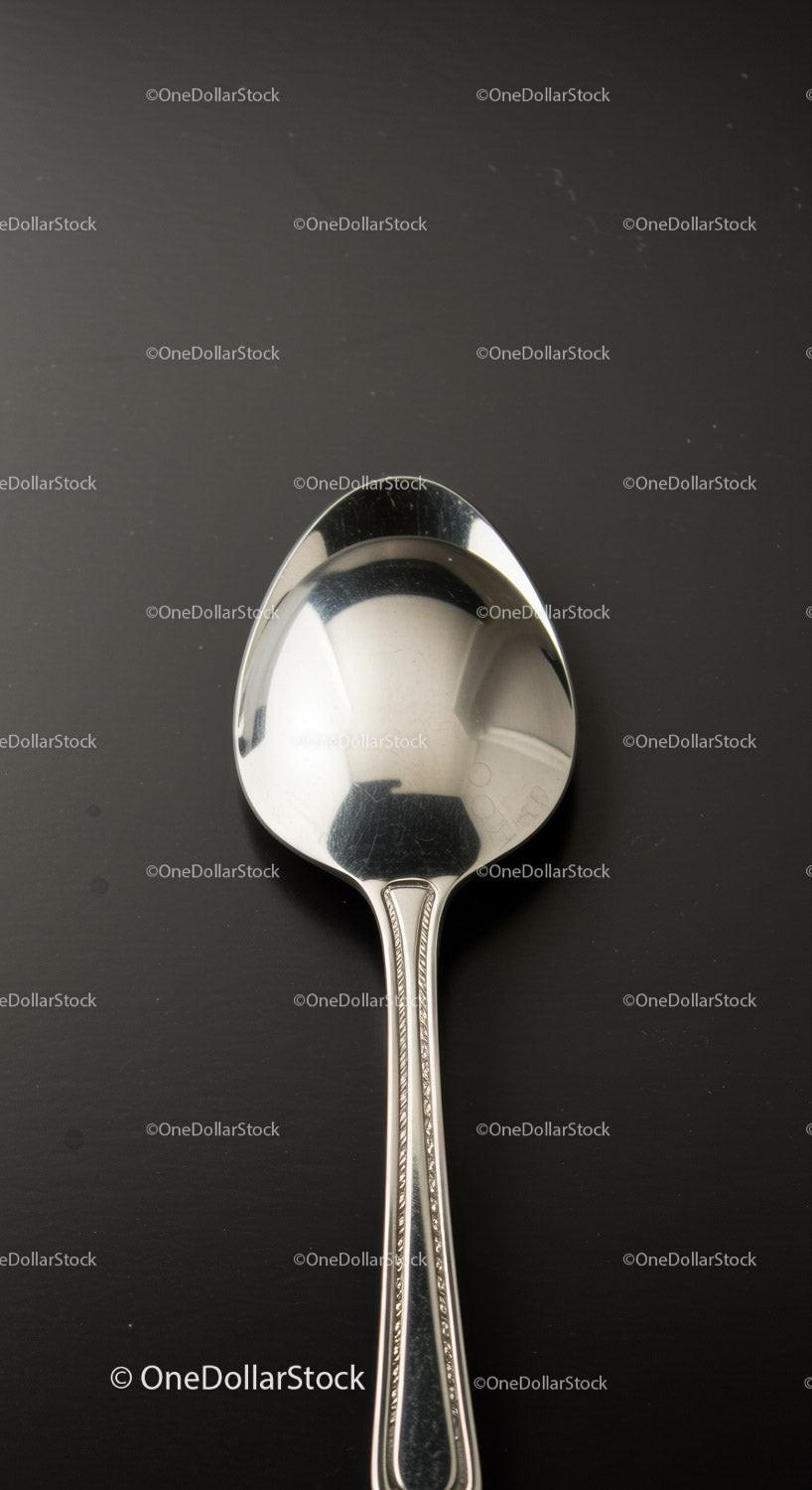 Classic silver spoon on a dark surface