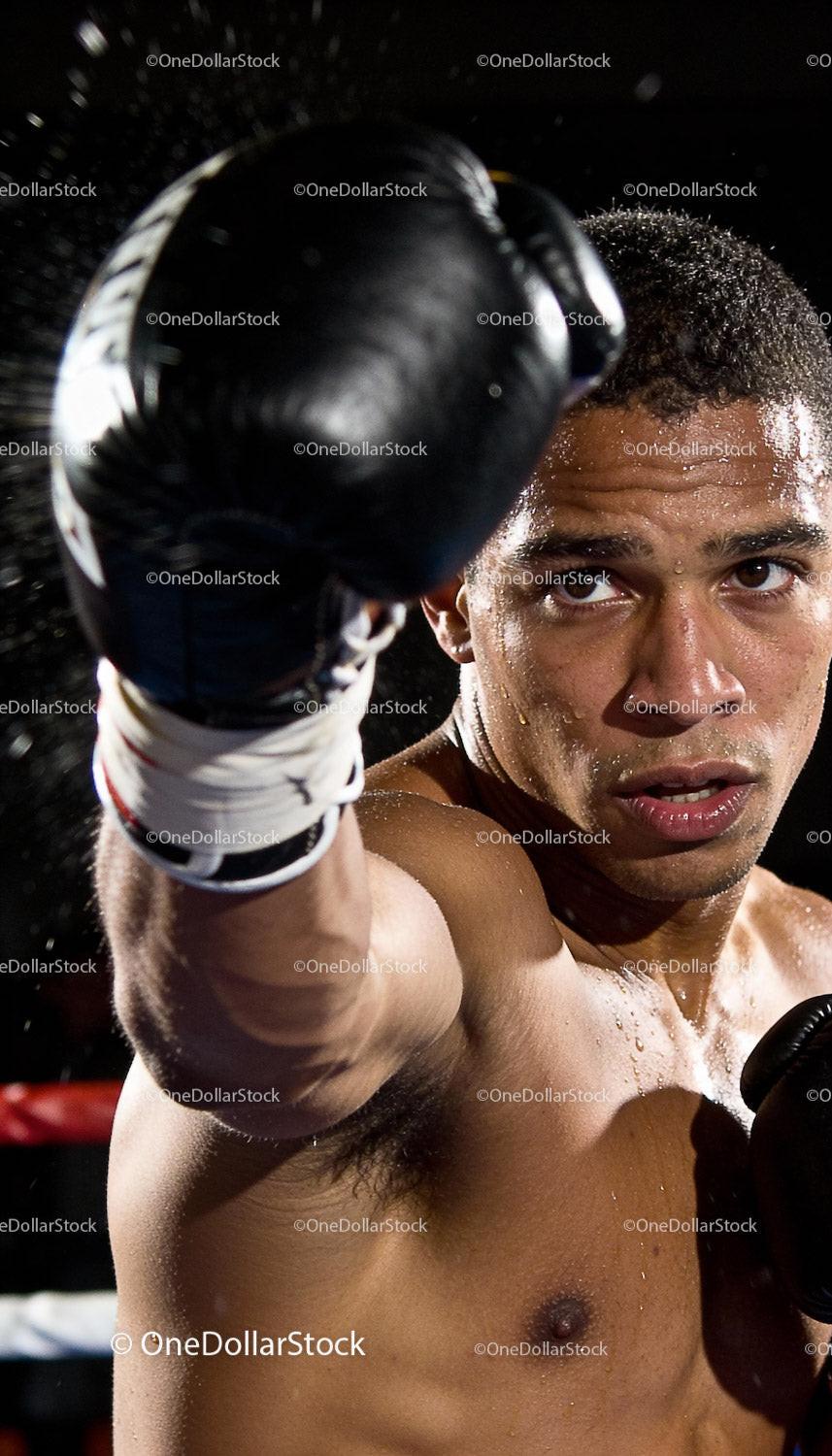 Focused male boxer delivering a powerful punch