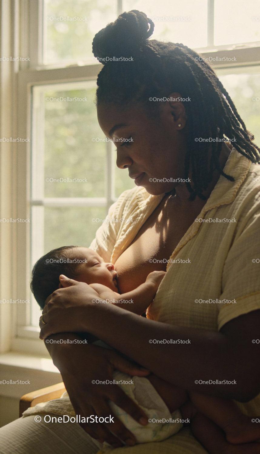 Mother Tenderly Breastfeeding Newborn in Soft Natural Light
