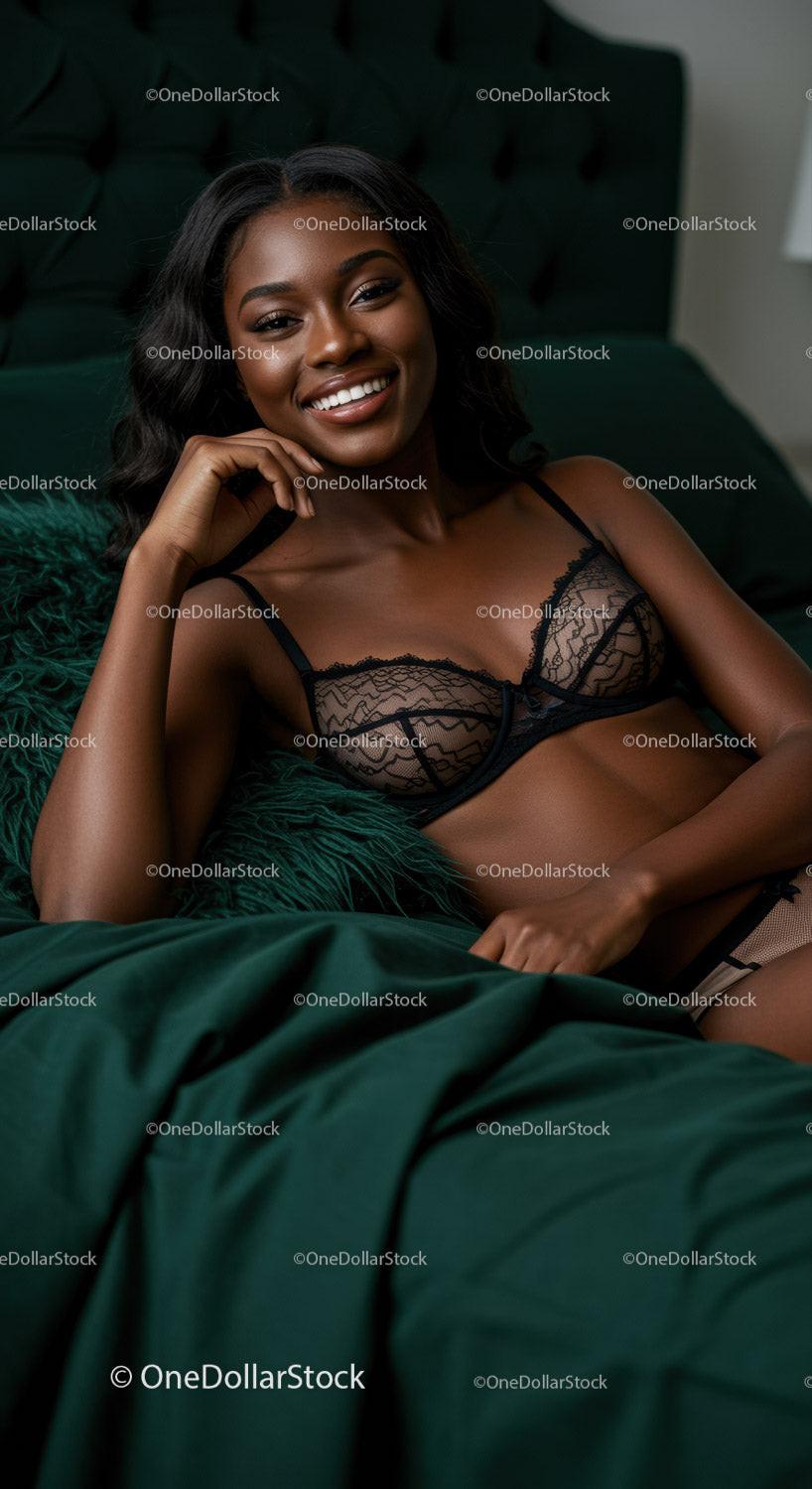 Smiling woman relaxing on dark green bed in lace lingerie