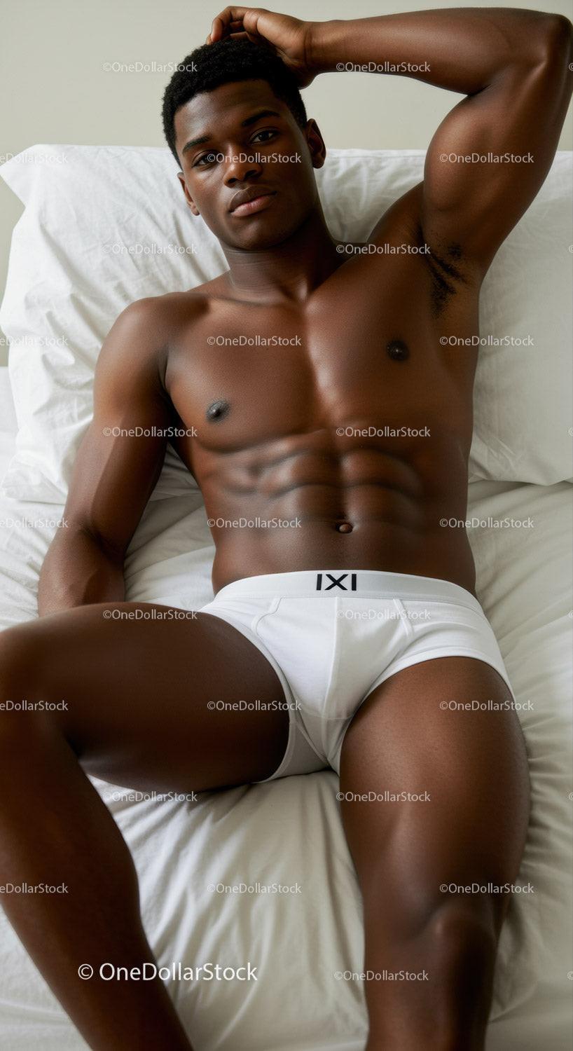 Relaxed young man lying on bed in white underwear