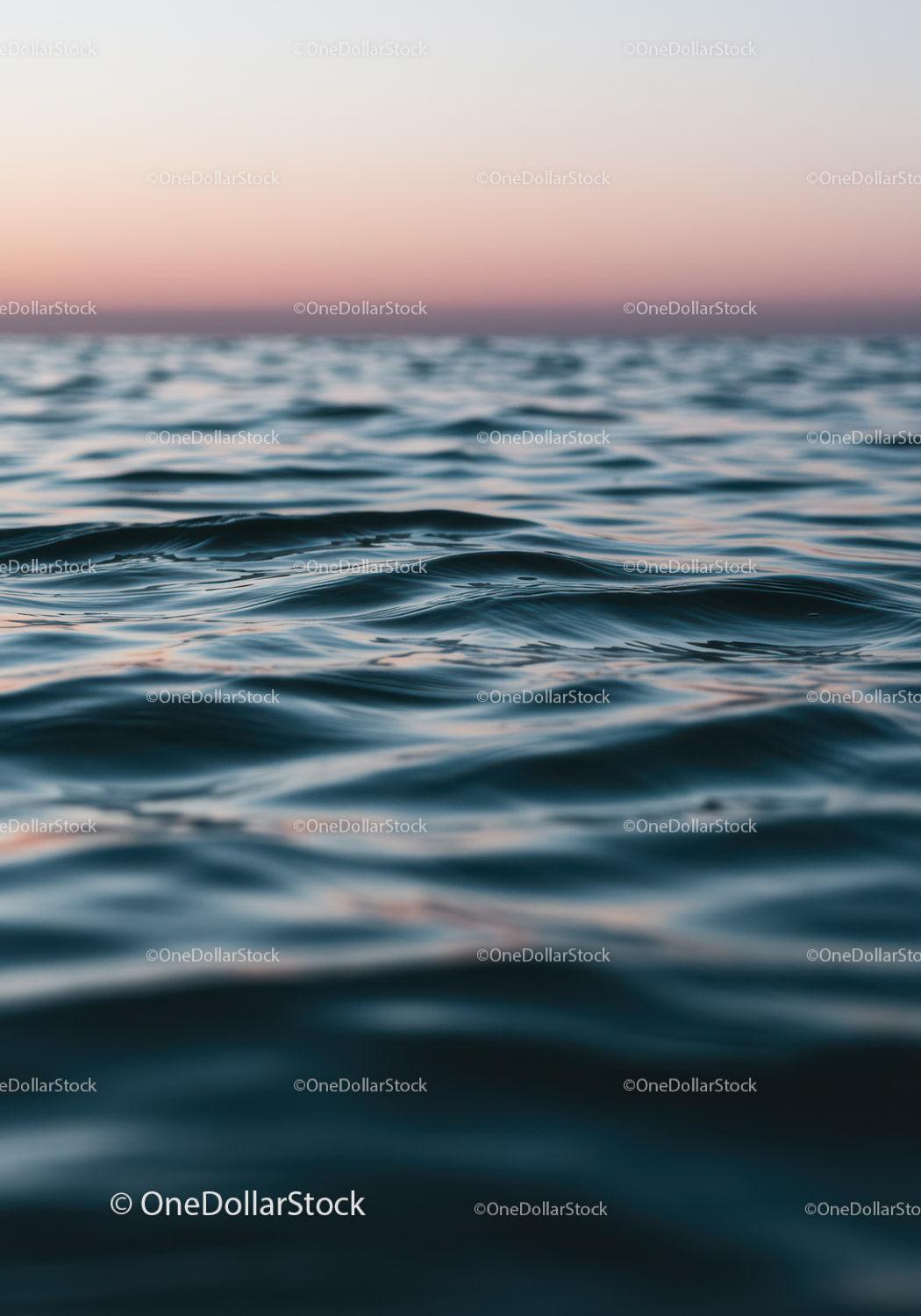 Serene Ocean Waves at Sunset with Pink and Blue Sky